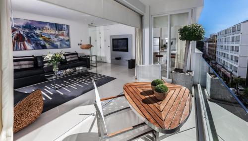 a living room with a table and a couch at BYD Lofts - Boutique Hotel & Serviced Apartments - Patong Beach, Phuket in Patong Beach