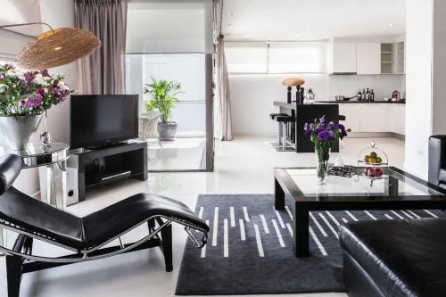 a living room with a couch and a table at BYD Lofts - Boutique Hotel & Serviced Apartments - Patong Beach, Phuket in Patong Beach