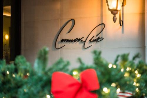 a christmas tree with a red bow in front of a sign at Virgin Hotels New Orleans in New Orleans