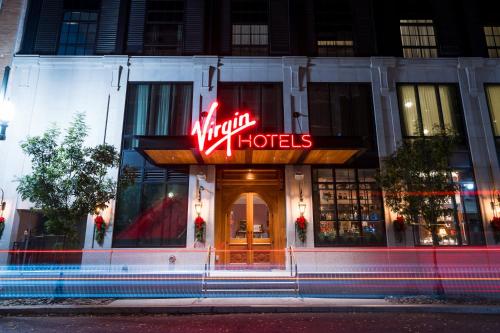 a hotel with a neon sign in front of it at Virgin Hotels New Orleans in New Orleans