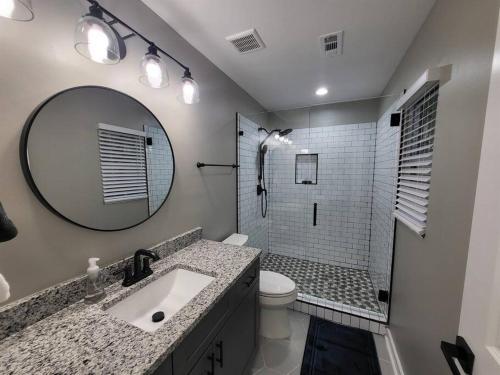 a bathroom with a sink and a toilet and a mirror at The Silver Comet in Atlanta