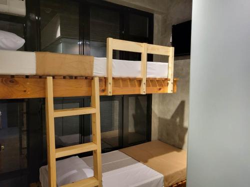 a bunk bed with a ladder in a room at Ramos Hello Stay Cebu in Cebu City