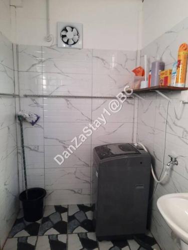 a small bathroom with a toilet and a sink at DanZaStay1@BC Nearby Thai Border in Padang Besar
