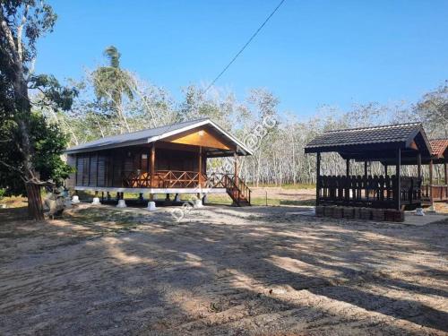 a small building with a pavilion in a field at DanZaStay1@BC Nearby Thai Border in Padang Besar