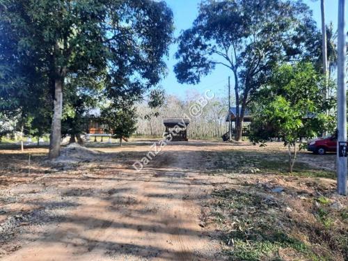 a dirt road in a park with trees and a car at DanZaStay1@BC Nearby Thai Border in Padang Besar