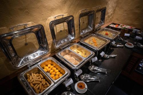 a bunch of trays of food on a table at Bar Peepal Resort in Pokhara