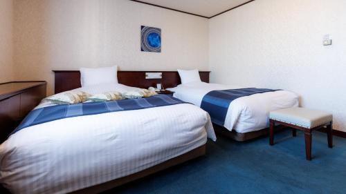 Tabist Abashiri Central Hotelにあるベッド