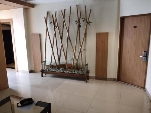 a room with a bunch of sticks on the wall at Hotel Madhav International Pune Railway Station in Pune