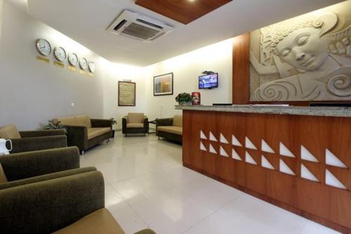 a waiting room with couches and a bar in a hospital at Hotel Madhav International Pune Railway Station in Pune