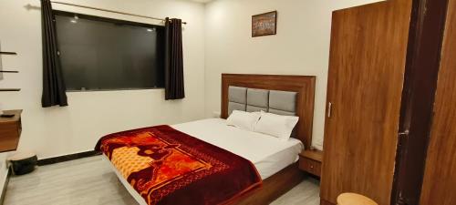 a bedroom with a bed with a large window at MD GRAND HOTEL & RESORT in Agra