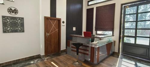 a room with a desk with a laptop on it at MD GRAND HOTEL & RESORT in Agra