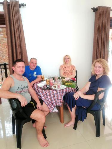 a group of people sitting around a table at Annasi Villa in Hikkaduwa