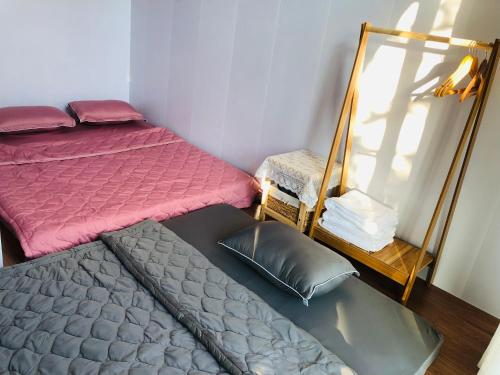 a small room with a bed and a mirror at Cóc Retreat Mỹ Tho City in My Tho