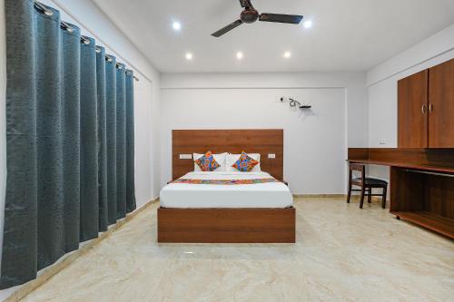 a bedroom with a bed and a piano at FabHotel Tree Suites in Bangalore