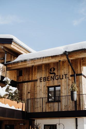a building with a sign on the side of it at Biohof Ebengut in Maria Alm am Steinernen Meer