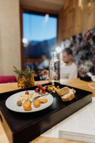 a plate of food on a black tray on a table at Biohof Ebengut in Maria Alm am Steinernen Meer