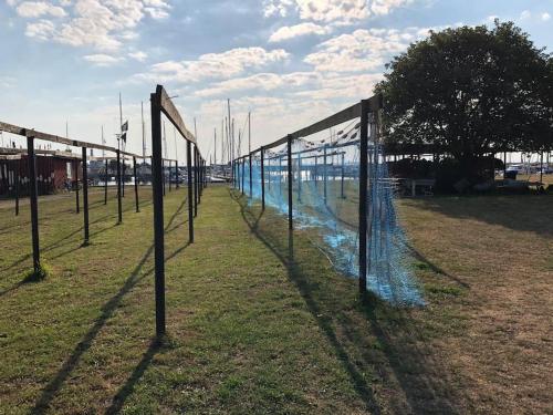 a row of volley ball nets in a field at Skønt fiskerhus. Tæt på by, havn og havet in Marstal