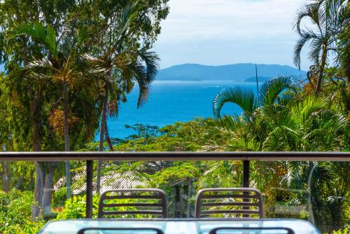 a view of the ocean from a table with chairs at Anchorage Apartments on Hamilton Island by HIHA in Hamilton Island