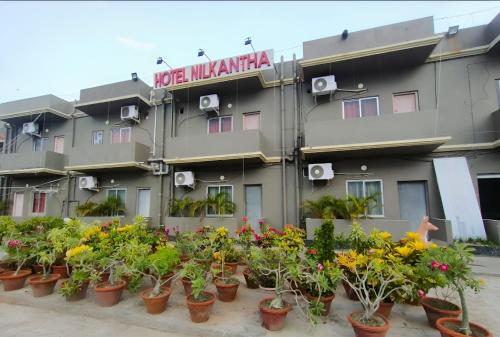 a building with flowers in front of it at Hotel Nilkantha in Mandarmoni
