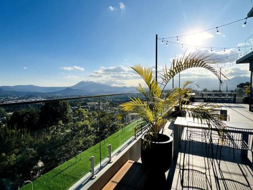 a balcony with a potted plant on top of it at Urban Gem: Comfort, Style, Views. Apartment close to the AIRPORT in Guatemala
