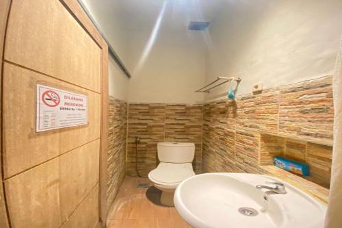 een badkamer met een toilet en een wastafel bij Treebox in Ngadipuro