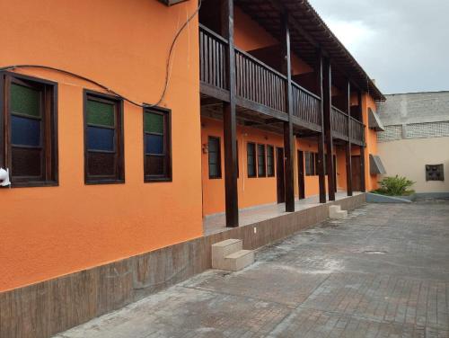 an orange building with a lot of windows on it at Hotel Pousada Em Guarapari - Pousada Paraiso in Guarapari