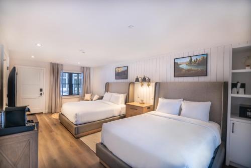 a hotel room with two beds and a television at Homestead Resort in Midway