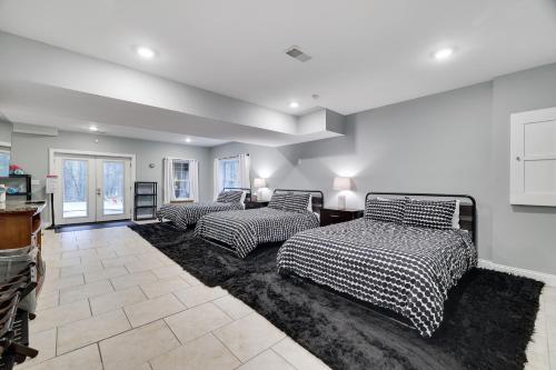 a room with three beds on a rug at Soose Manor Spa BBQ Games and Bar Near Lake in Tafton