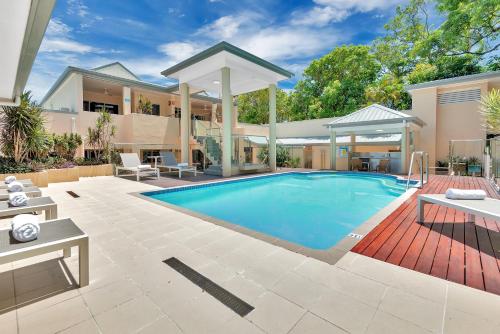 a swimming pool in the backyard of a house at The Newport on Macrossan - Adults Only in Port Douglas