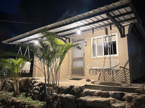 a house with a swing in the front yard at night at 南苑莊園 NanYuan Resort Manor in Nanzhuang