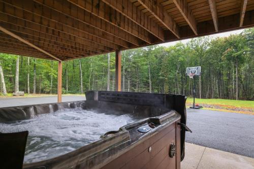 a large hot tub in a covered patio at Soose Manor Spa BBQ Games and Bar Near Lake in Tafton