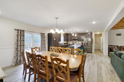 a dining room and kitchen with a table and chairs at Soose Manor Spa BBQ Games and Bar Near Lake in Tafton