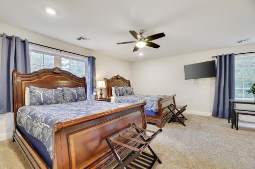 a bedroom with a bed and a desk and a fan at Soose Manor Spa BBQ Games and Bar Near Lake in Tafton
