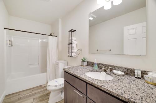 a bathroom with a sink and a toilet and a mirror at Soose Manor Spa BBQ Games and Bar Near Lake in Tafton