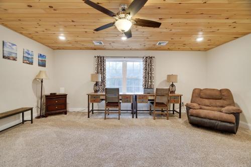 a living room with a desk and a ceiling fan at Soose Manor Spa BBQ Games and Bar Near Lake in Tafton