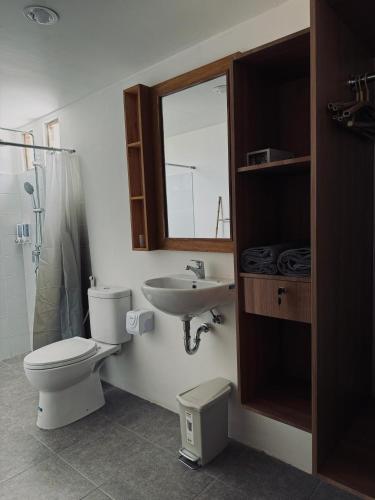 a bathroom with a toilet and a sink at Uma Pantai Seseh in Canggu