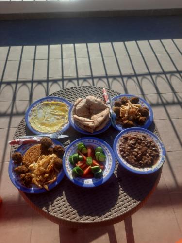 a table with plates of food on a table at FADL Kato in Aswan