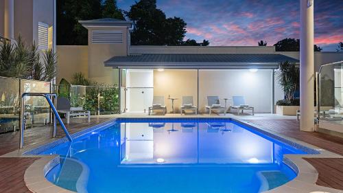 a swimming pool in the backyard of a house at The Newport on Macrossan - Adults Only in Port Douglas