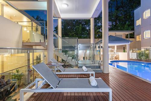 a balcony of a house with a swimming pool at The Newport on Macrossan - Adults Only in Port Douglas