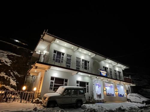 a truck parked in front of a building at night at Himalayan Canvas khajjiar in Khajjiar 
