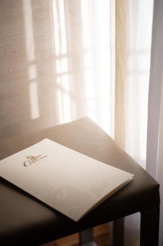 a white envelope sitting on a table next to a window at Charme Hotel in Prato