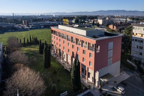 an overhead view of a large brick building with trees at Charme Hotel in Prato