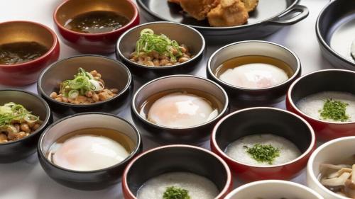 a group of bowls of food with rice and broccoli at Dormy Inn Express Kakegawa in Kakegawa