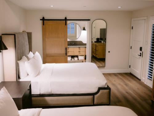 a bedroom with two beds and a mirror at Homestead Resort in Midway