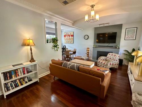 a living room with a couch and a tv at West Busselton Cottage in Broadwater
