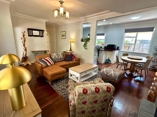 a living room with a couch and a table at West Busselton Cottage in Broadwater
