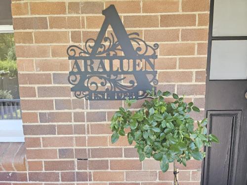a sign on the side of a brick building at Araluen, Heart of Bowral in Bowral