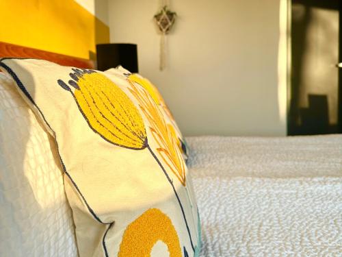 a bed with a blanket on top of it at Guesthouse De Wissen in Dilsen-Stokkem