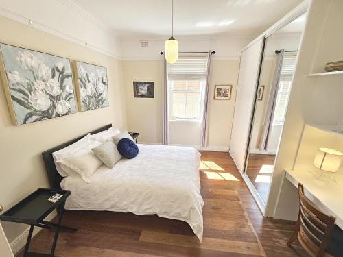 a bedroom with a bed with white sheets and pillows at New: Araluen, Heart of Bowral in Bowral