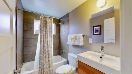 a bathroom with a sink and a toilet and a shower at Downtown Cozy Home Base - Purple Sage 6 in Moab
